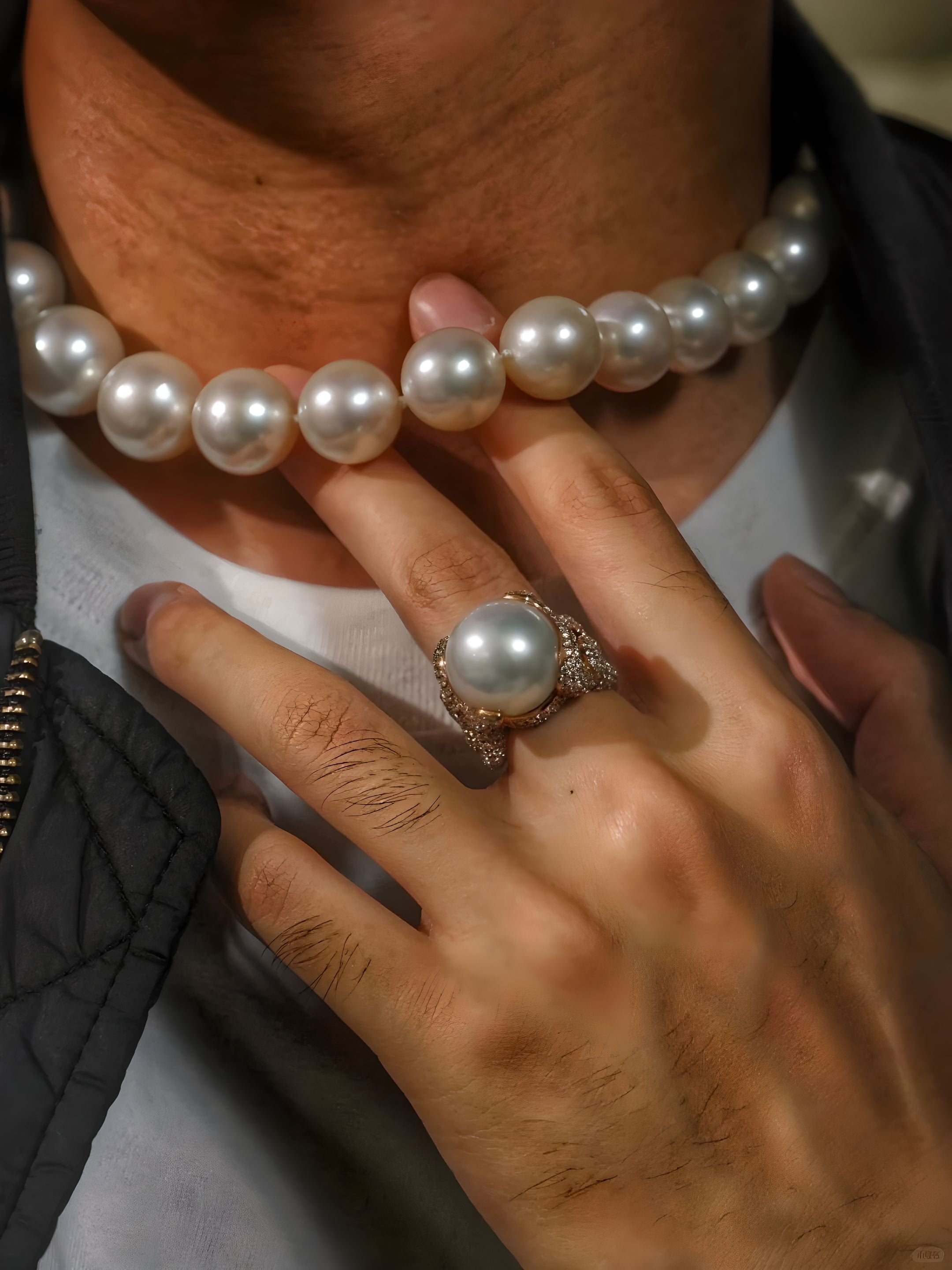 Man with pearl necklace and pearl ring