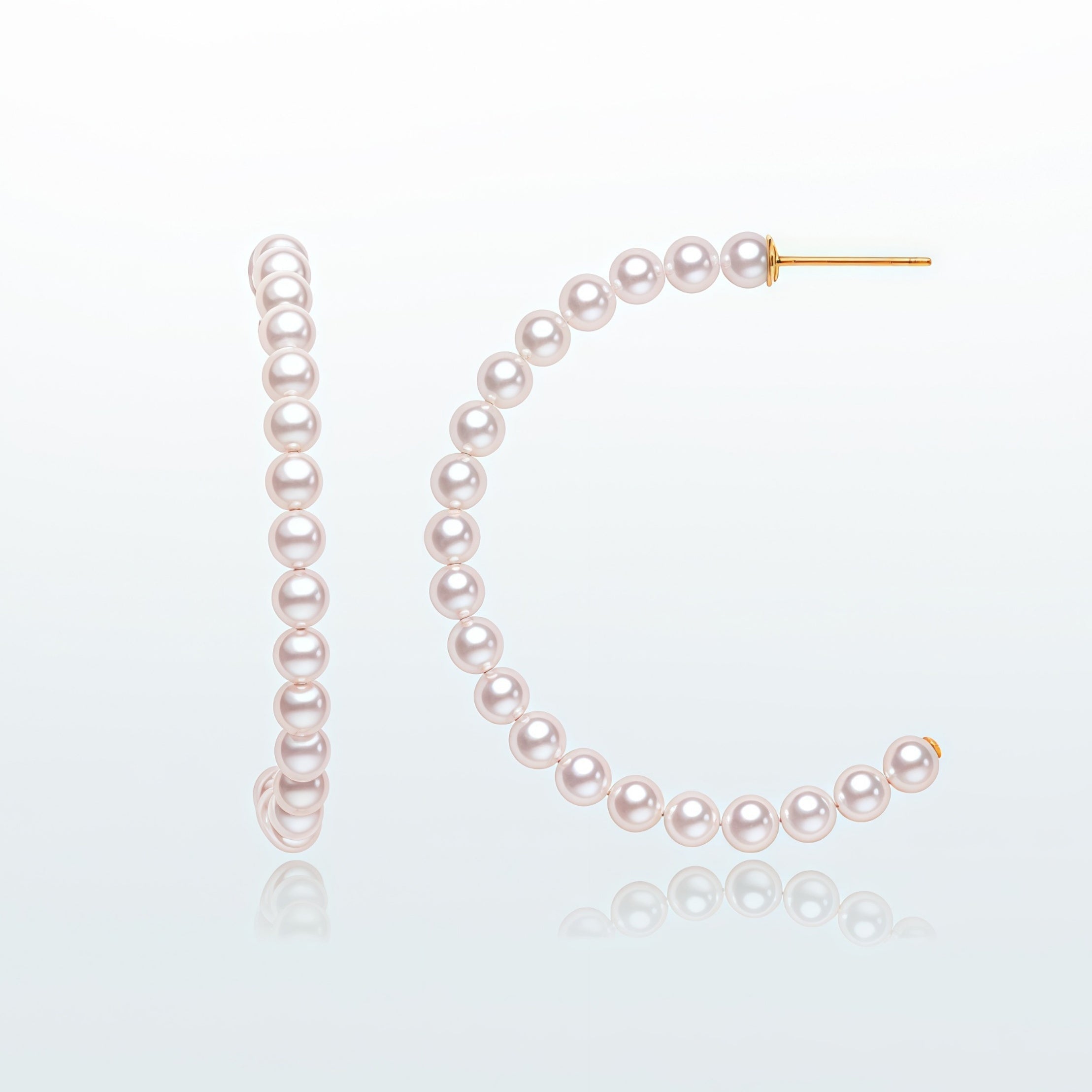 Minimal freshwater pearl hoop earrings in a clean product image with white pearls and gold-tone posts