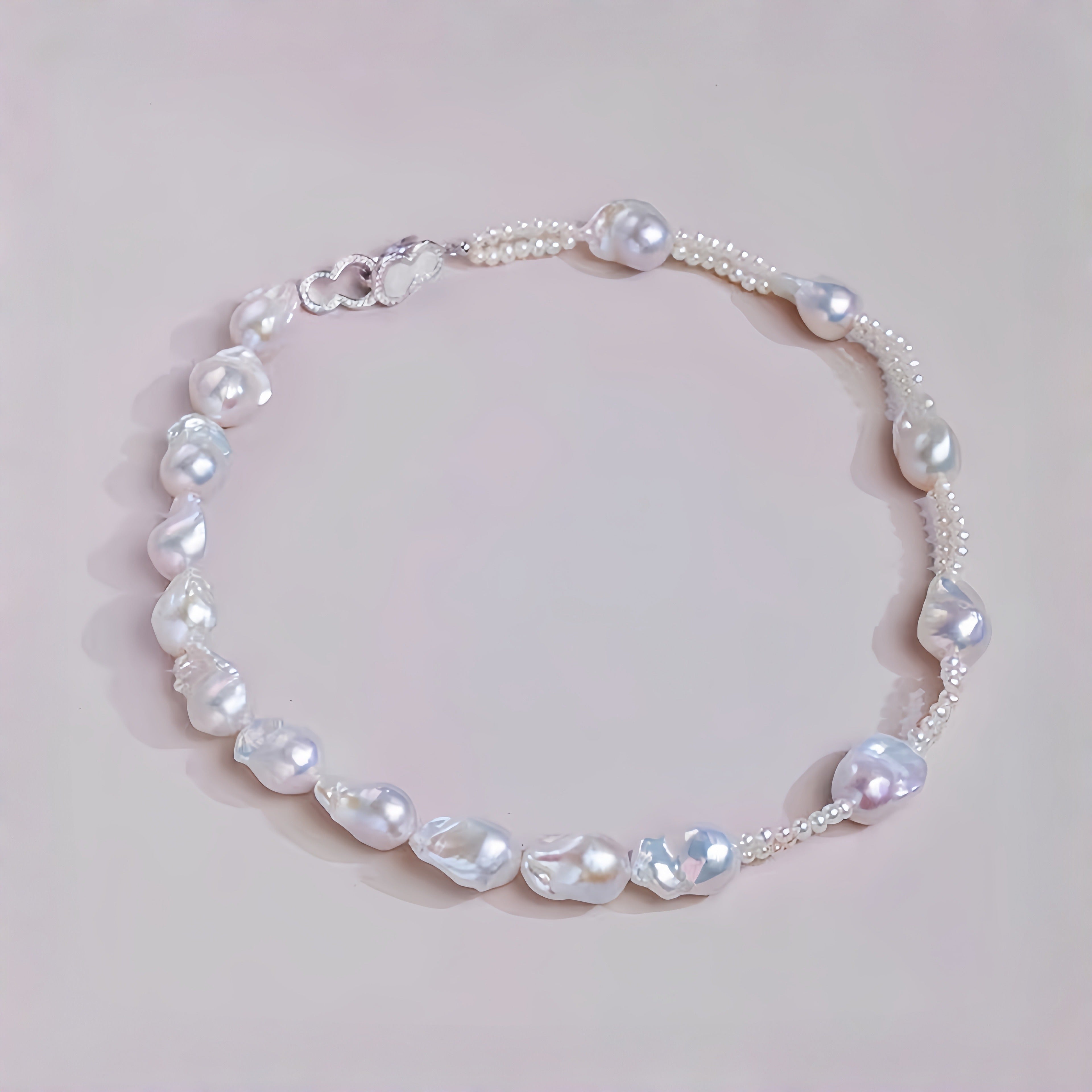 Pearl necklace on a light pink background