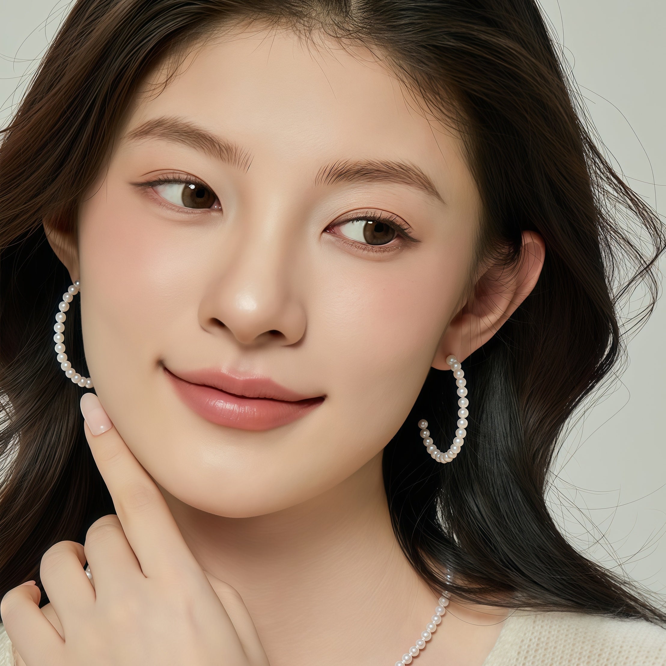 Model wearing freshwater pearl hoop earrings with bright white rice pearls for an elegant everyday look
