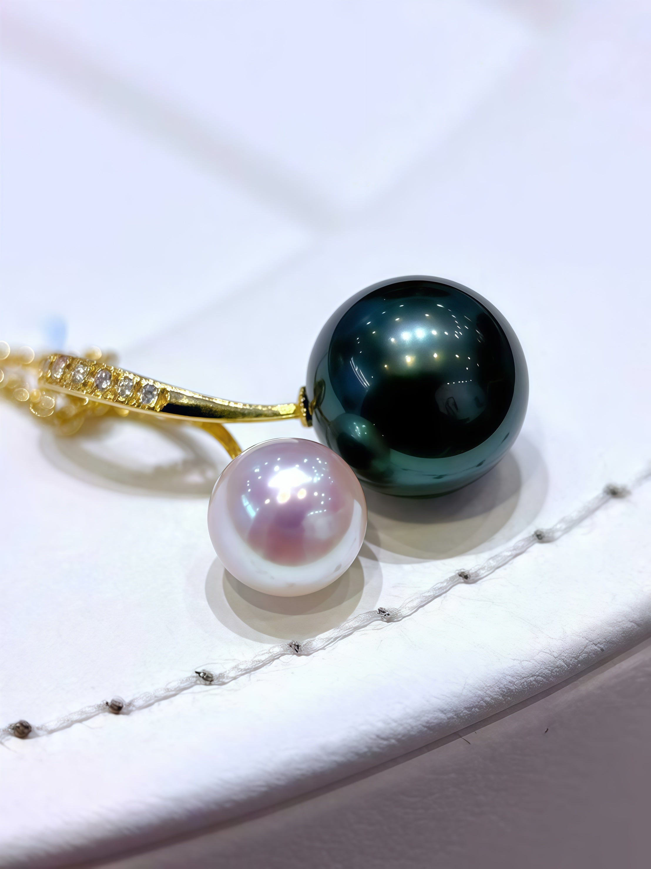 Pearl and black pearl necklace on a white background